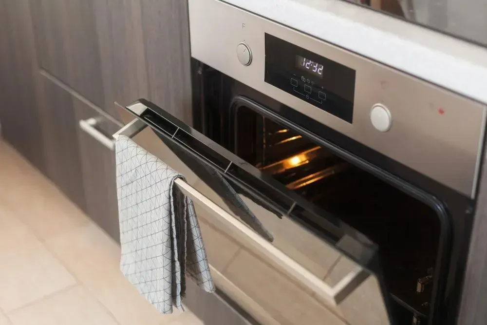 A Silver Wall Oven With Its Door Partially Open — Eurocoast Appliance Service In Bateau Bay, NSW