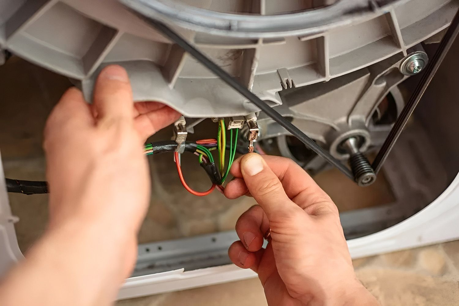 Hands Working on Electrical Wiring — Eurocoast Appliance Service In Tuggerah, NSW
