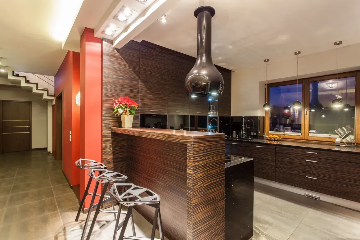 A kitchen with a bar and stools in it