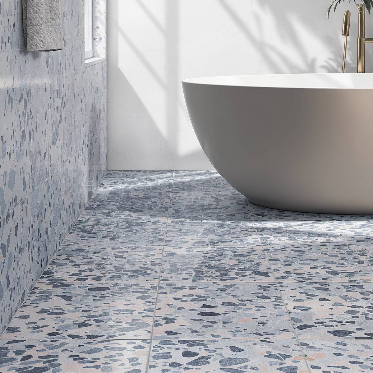 Bathroom with blue terrazzo tile floor and wall; white bathtub.