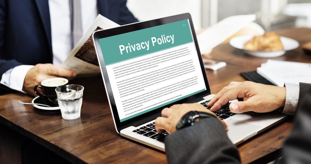 Man Reading a Privacy Policy on a Laptop — Reputable Insurance Broker in Medowie, NSW