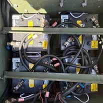 Internal view of electronic equipment with wires and connectors in a metal cabinet.