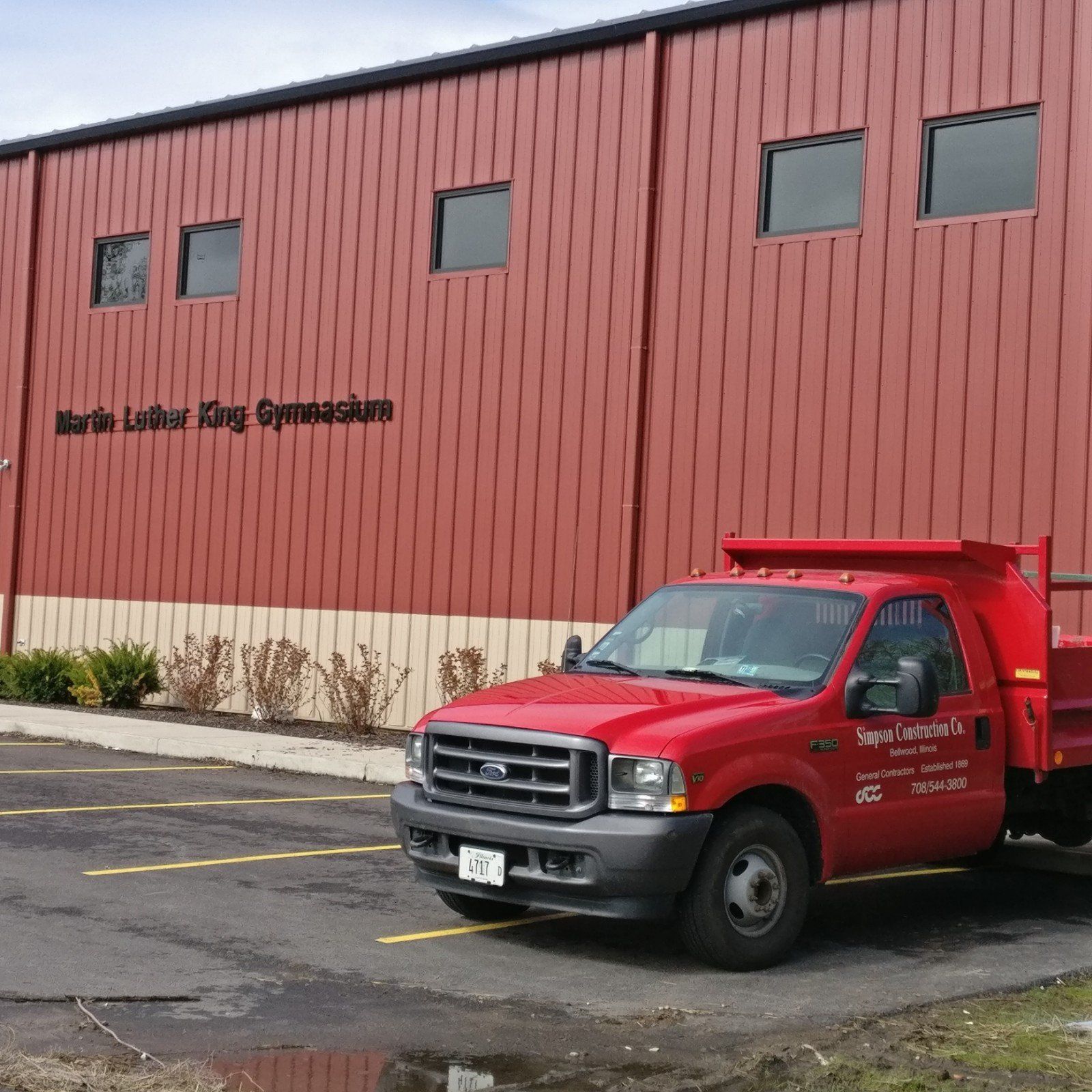 A red truck is parked in front of martin luther king gymnasium