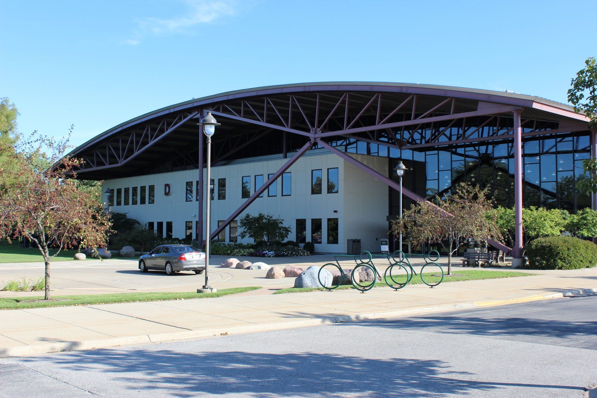 A large building with a purple roof and a car parked in front of it