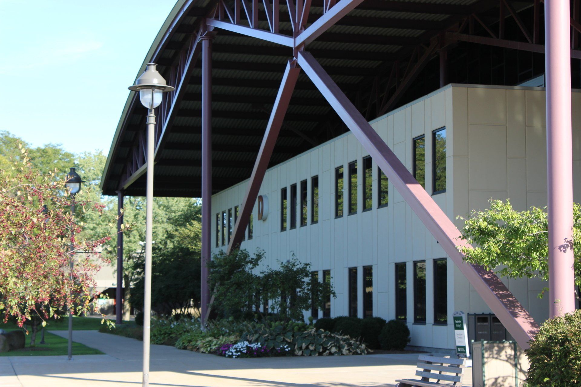 A large white building with a purple roof