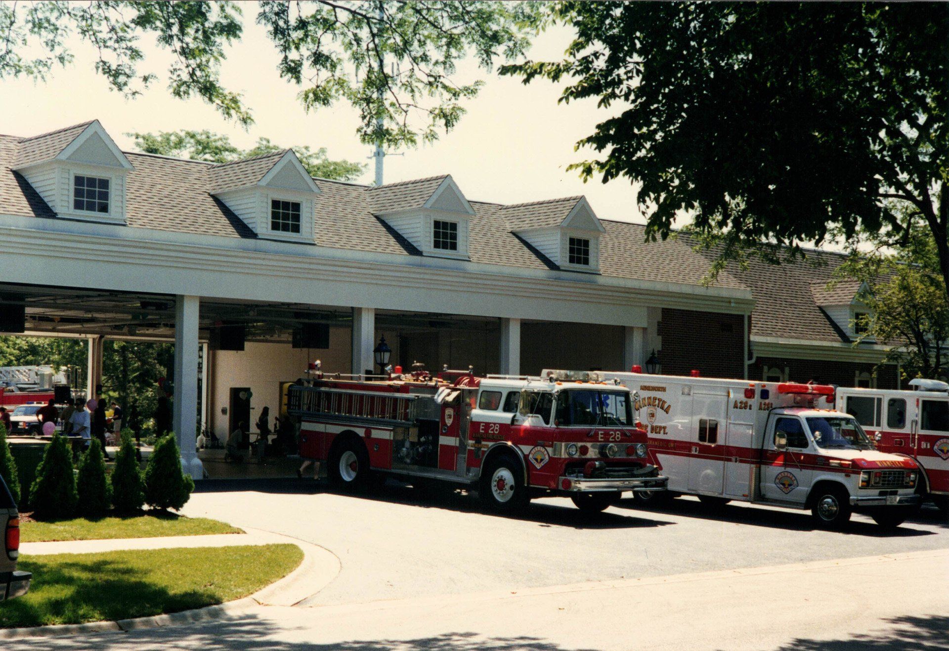 A row of fire trucks are parked in front of a building