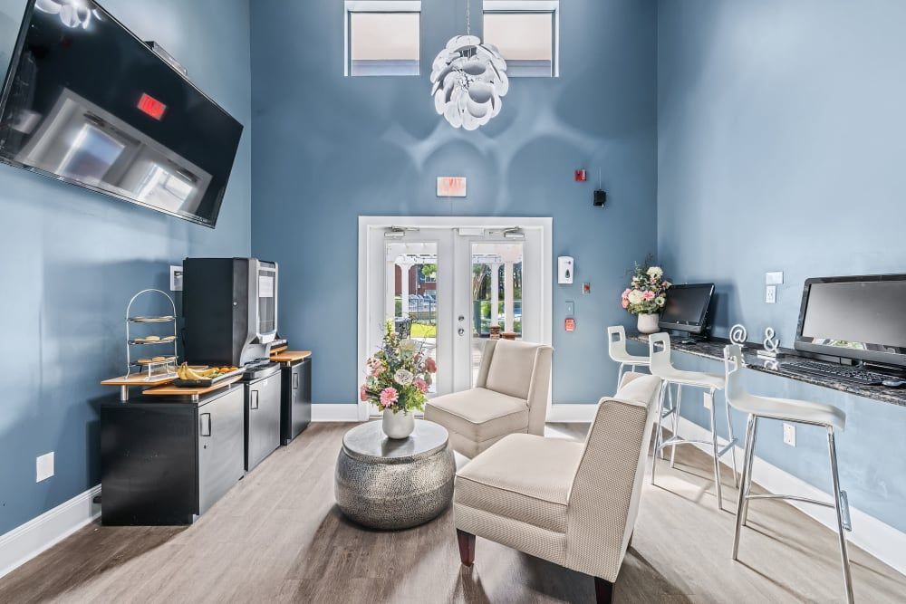 a living room with chairs, a table, and a television at Marquis on Gaston in Dallas, TX.