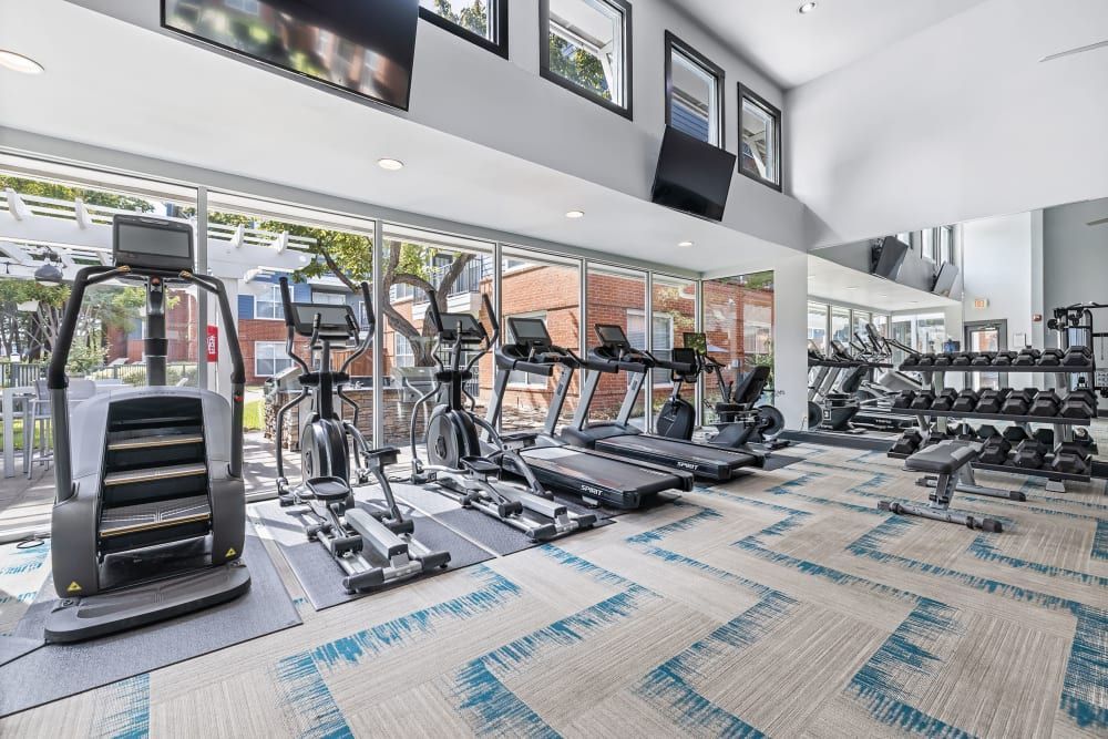 a large gym filled with a variety of exercise equipment at Marquis on Gaston in Dallas, TX.