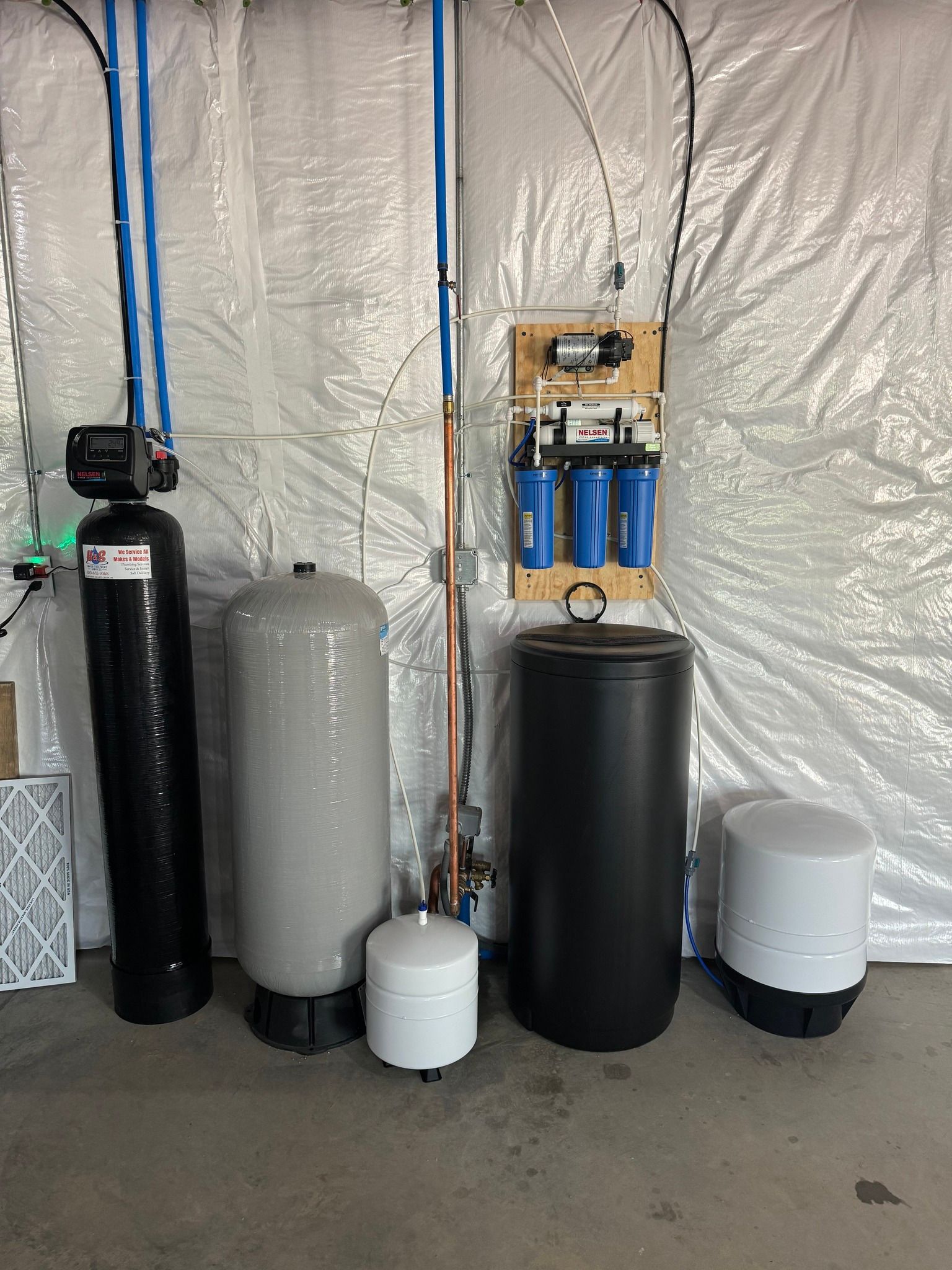 A water treatment system is installed in a basement.