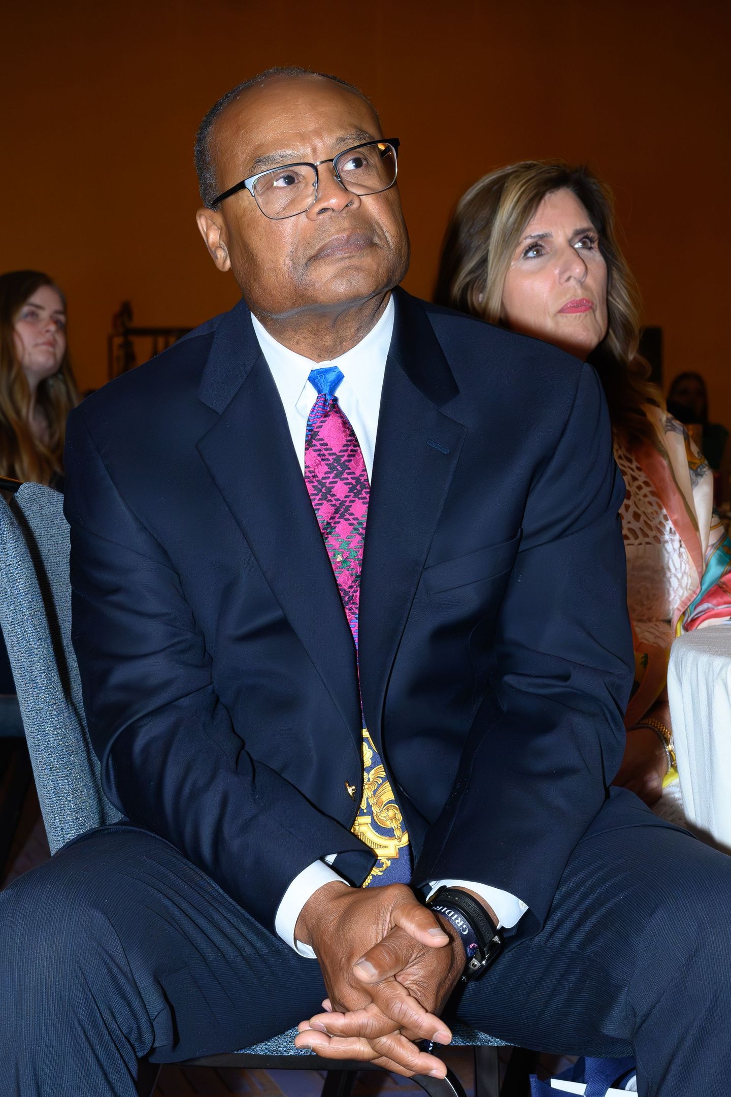NFL legend Mike Singletary listening while at a conference.