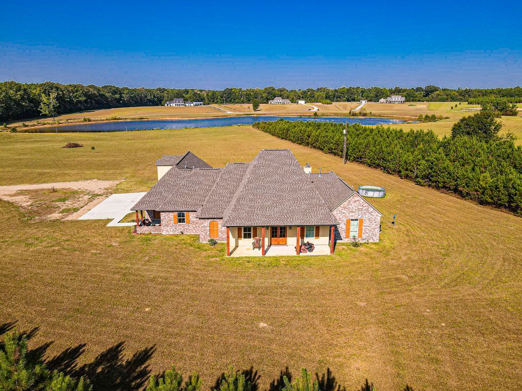 Awesome custom home on 10 acres and a private, stocked lake!