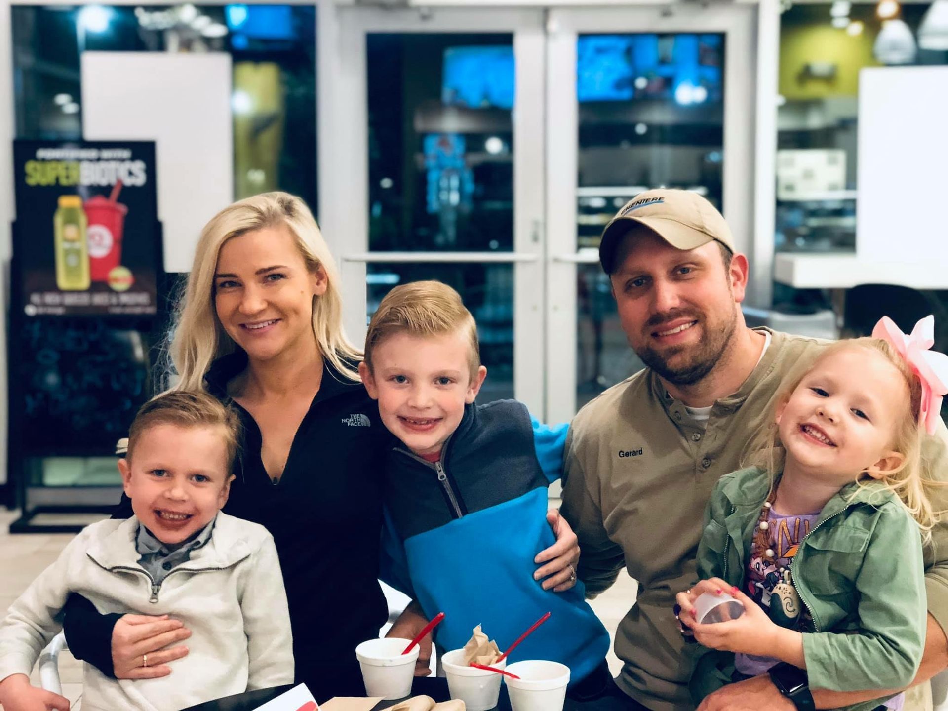 A family is posing for a picture in a restaurant.