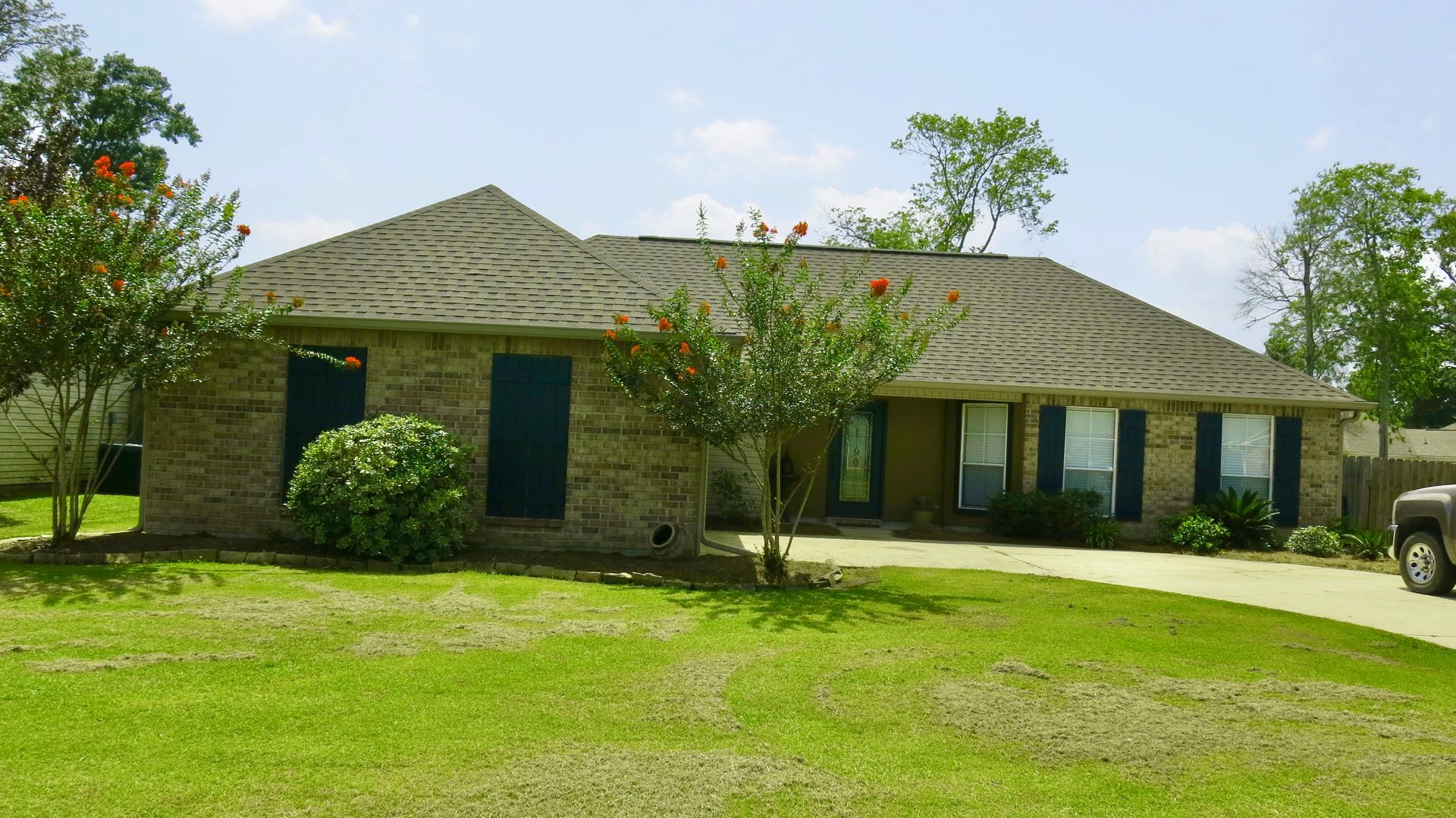 A brick house with a truck parked in front of it