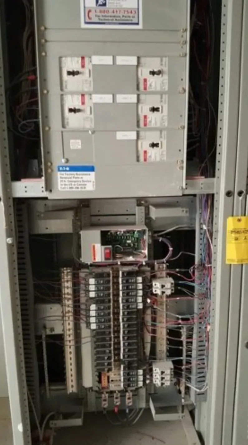 A row of houses with a blue dumpster parked in front of them.