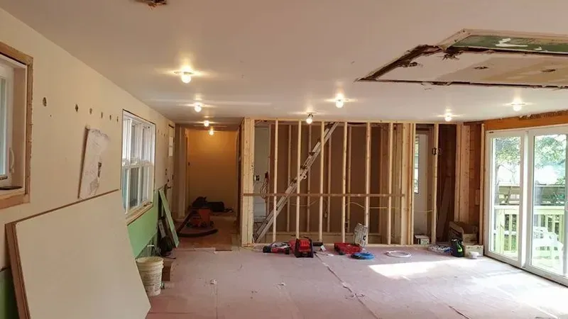 A large room with a lot of windows is being remodeled.