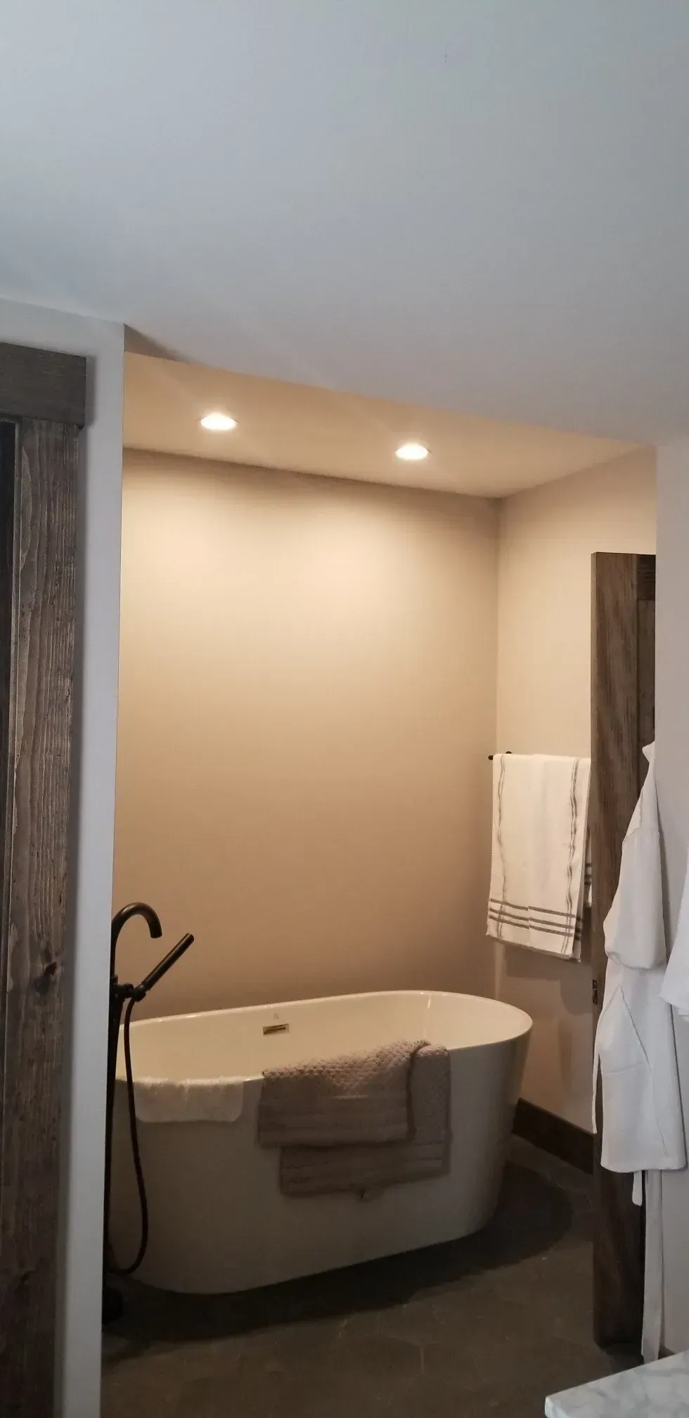 A bathroom with a bathtub and a shower.
