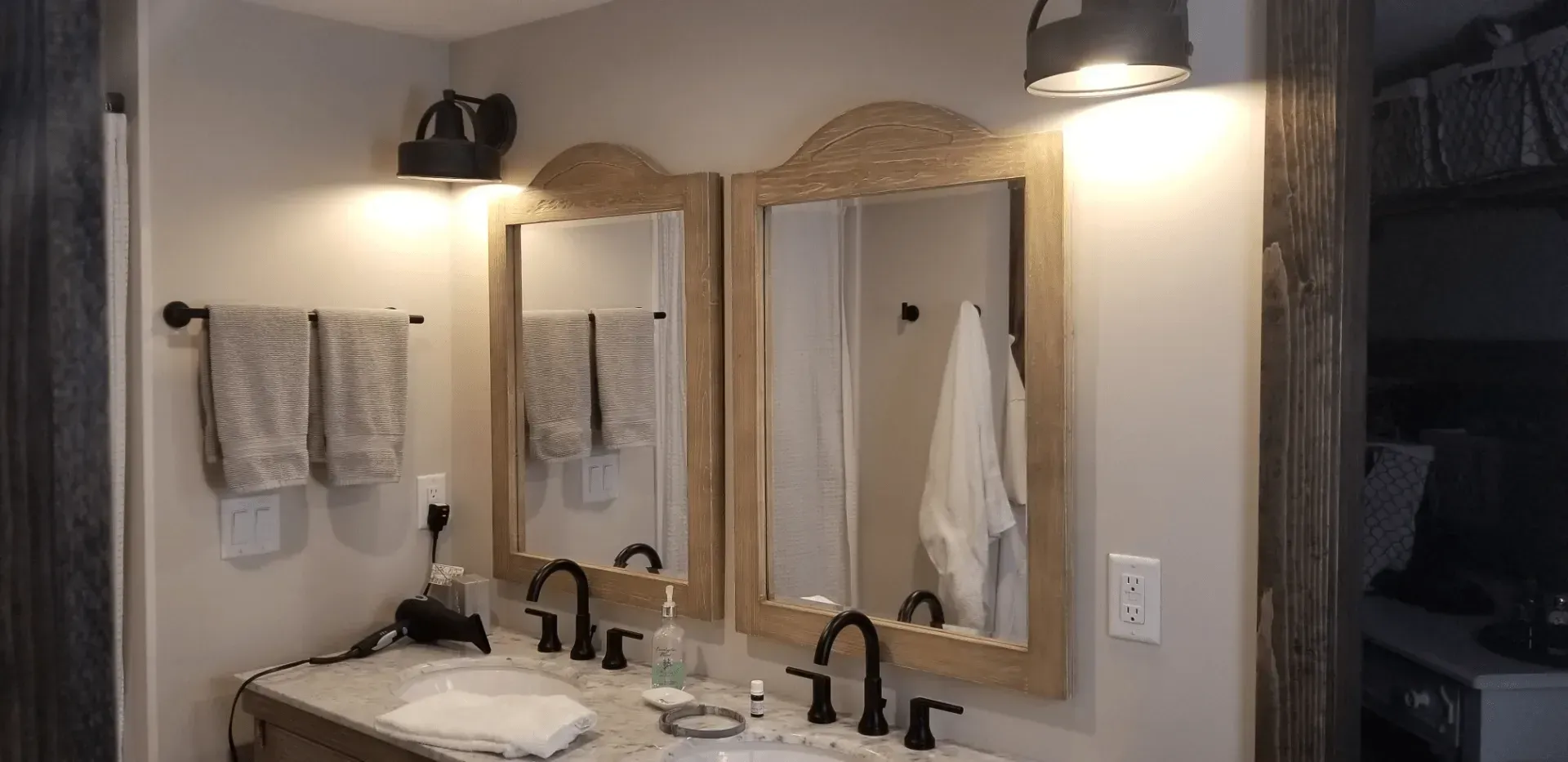 A bathroom with two sinks and two mirrors.
