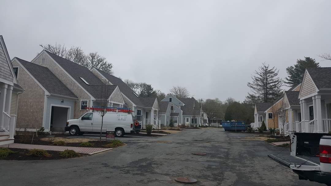 A row of houses are lined up on the side of a road.