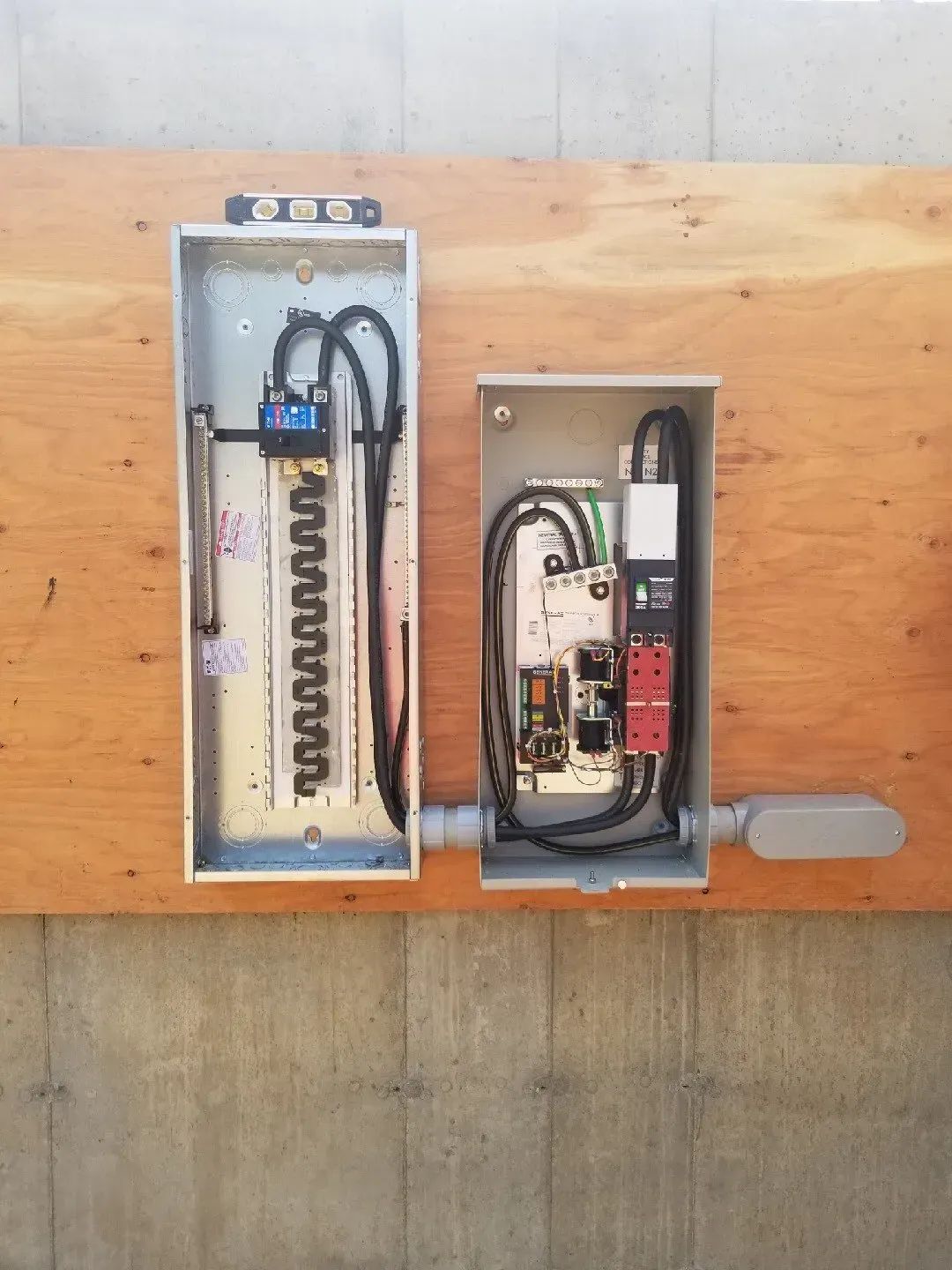 Two electrical boxes are sitting on top of a wooden table.