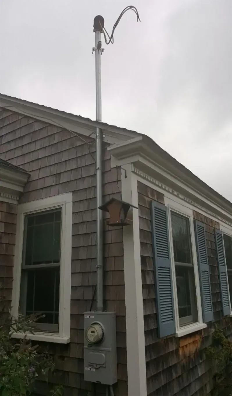 A house with a birdhouse on the side of it
