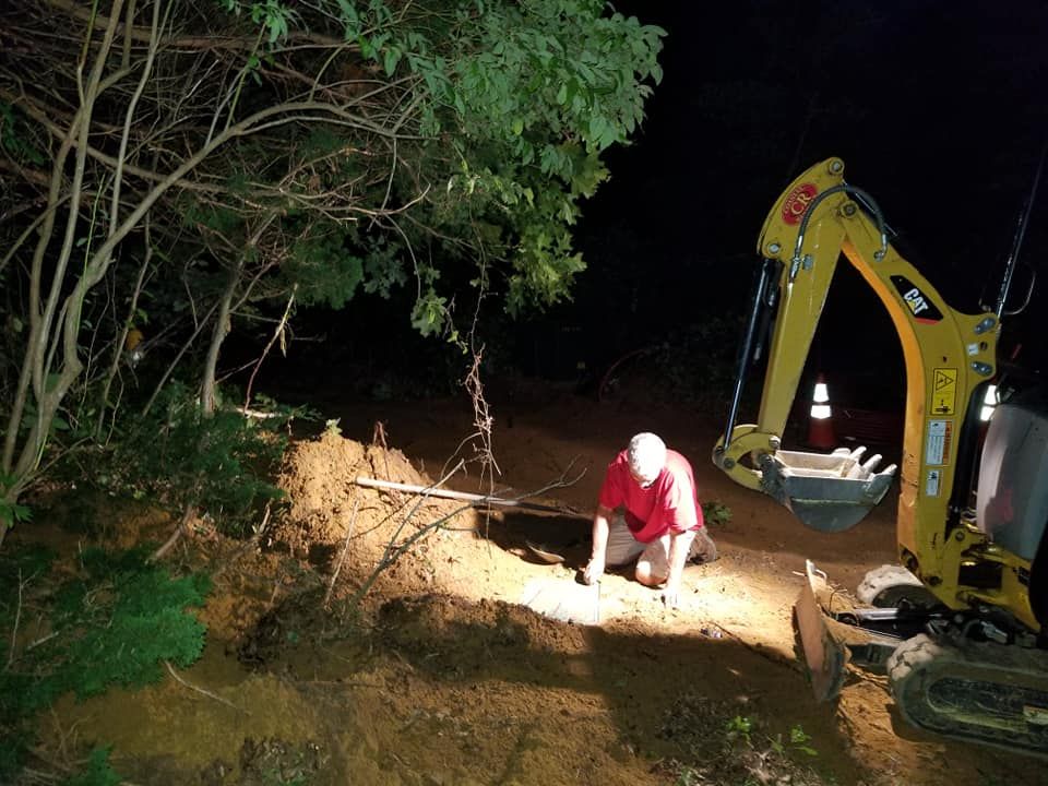 J.W. Electric sign with phone number, logo of a lightbulb, and license information.