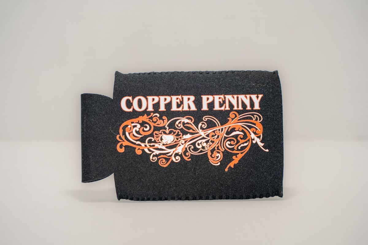 Black can cooler with "Copper Penny" in orange script and flourishes.