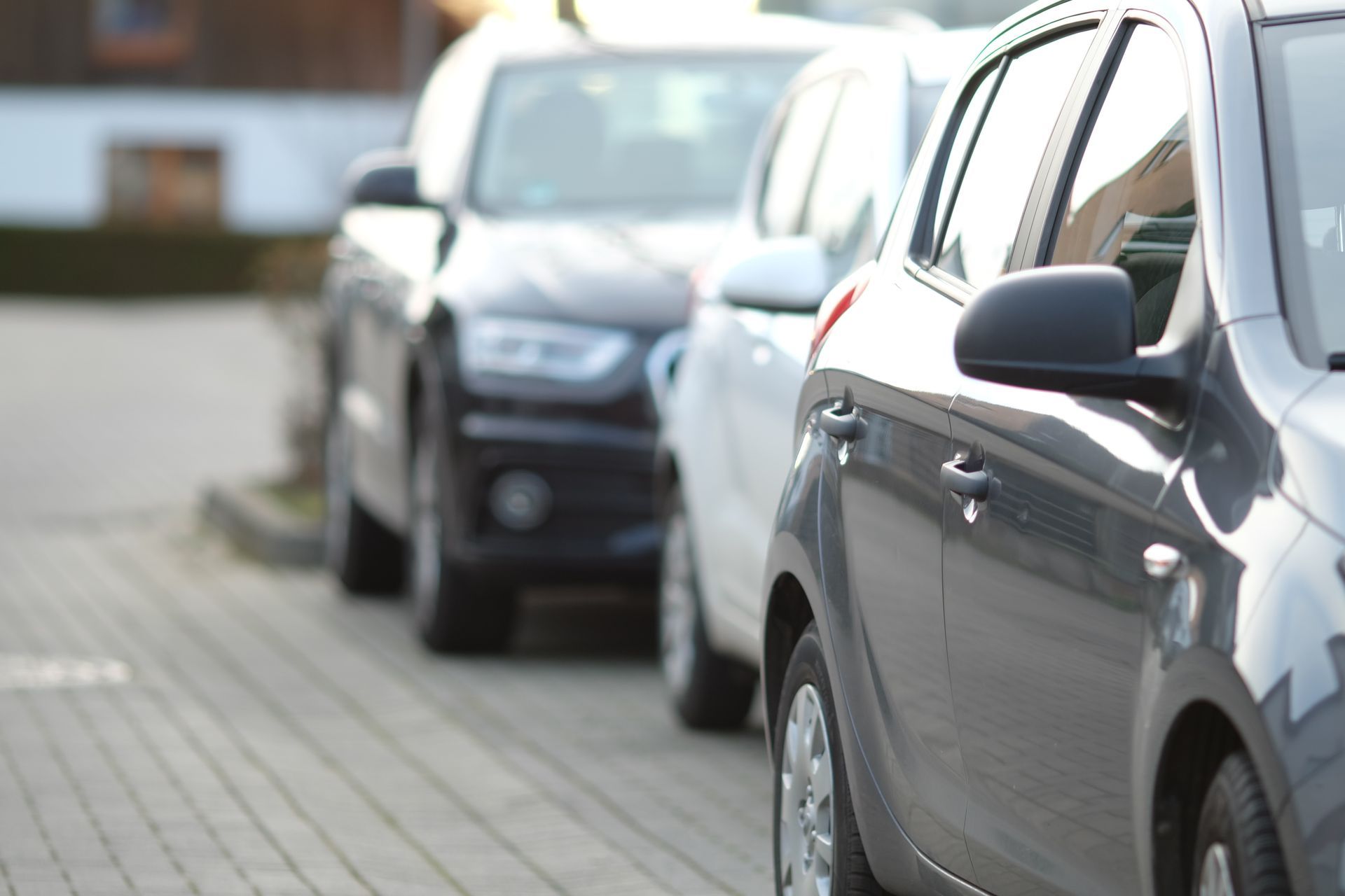 en række biler er parkeret på en parkeringsplads
