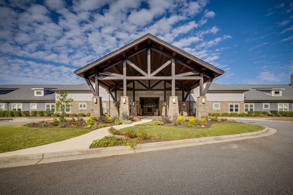 A large building with a wooden roof and a walkway leading to it.