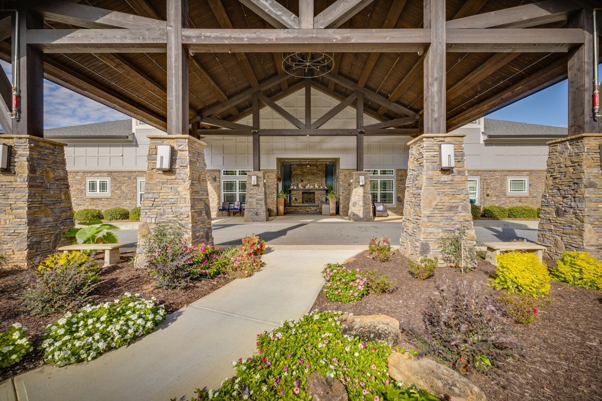 A large building with a covered entrance and a walkway leading to it.