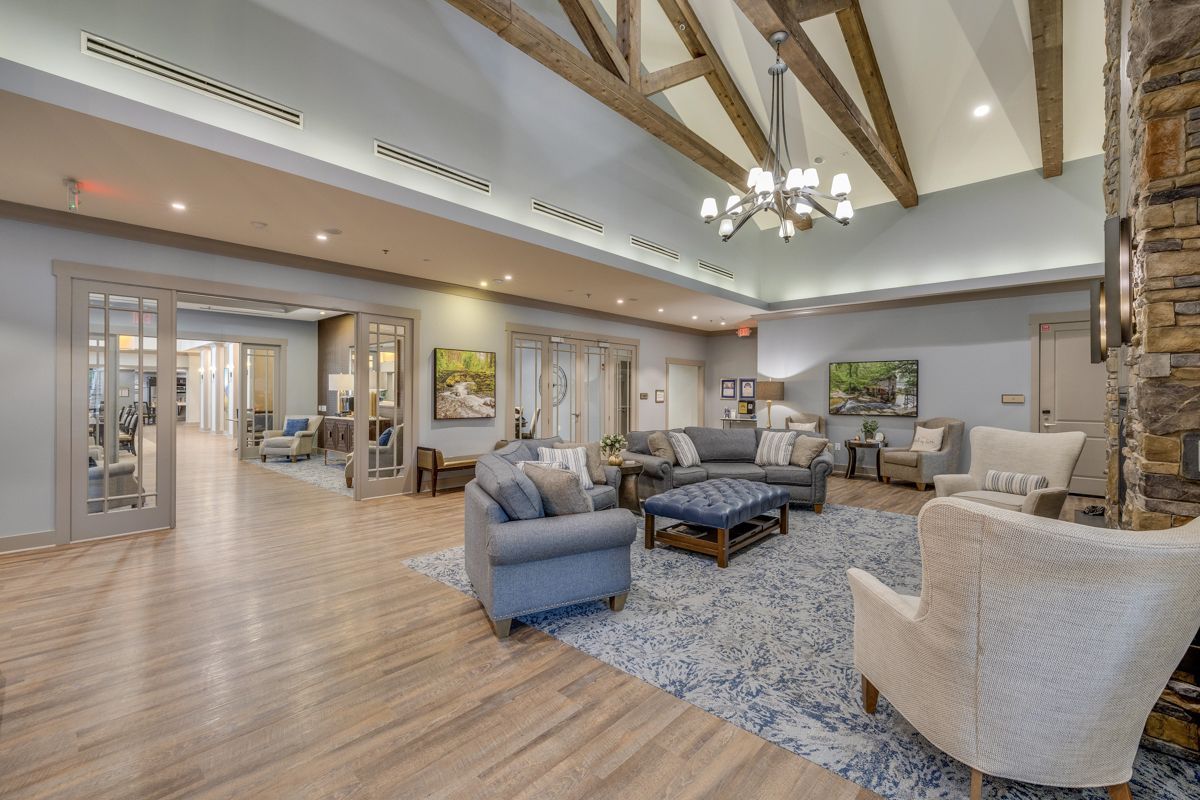 A living room filled with furniture and a chandelier.