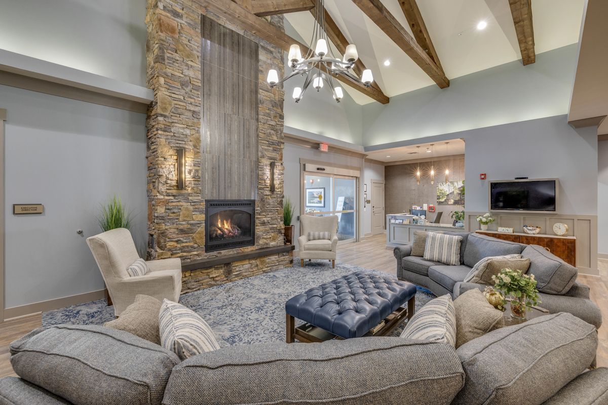 A living room filled with furniture and a fireplace.