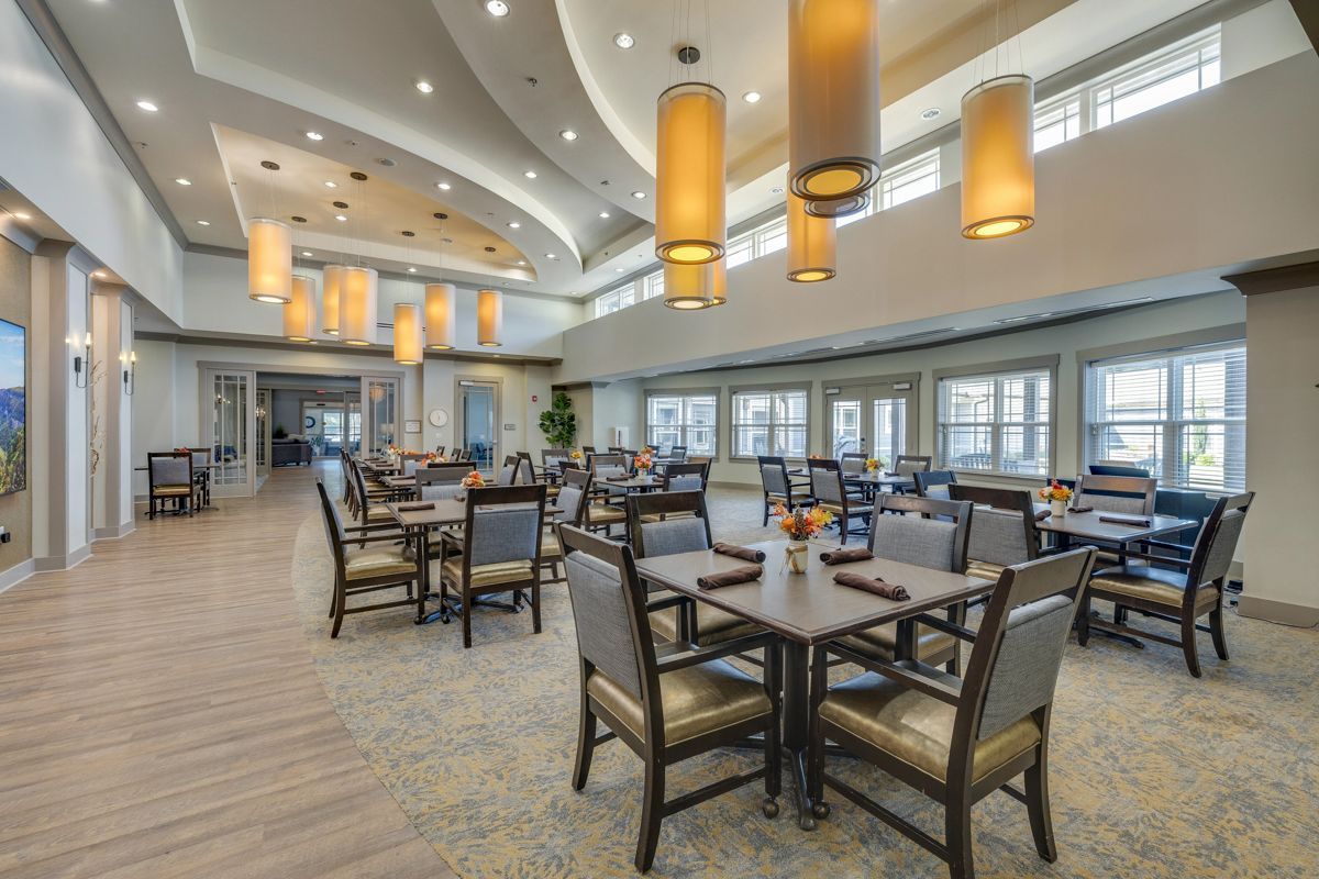 A large dining room with tables and chairs in a hotel.