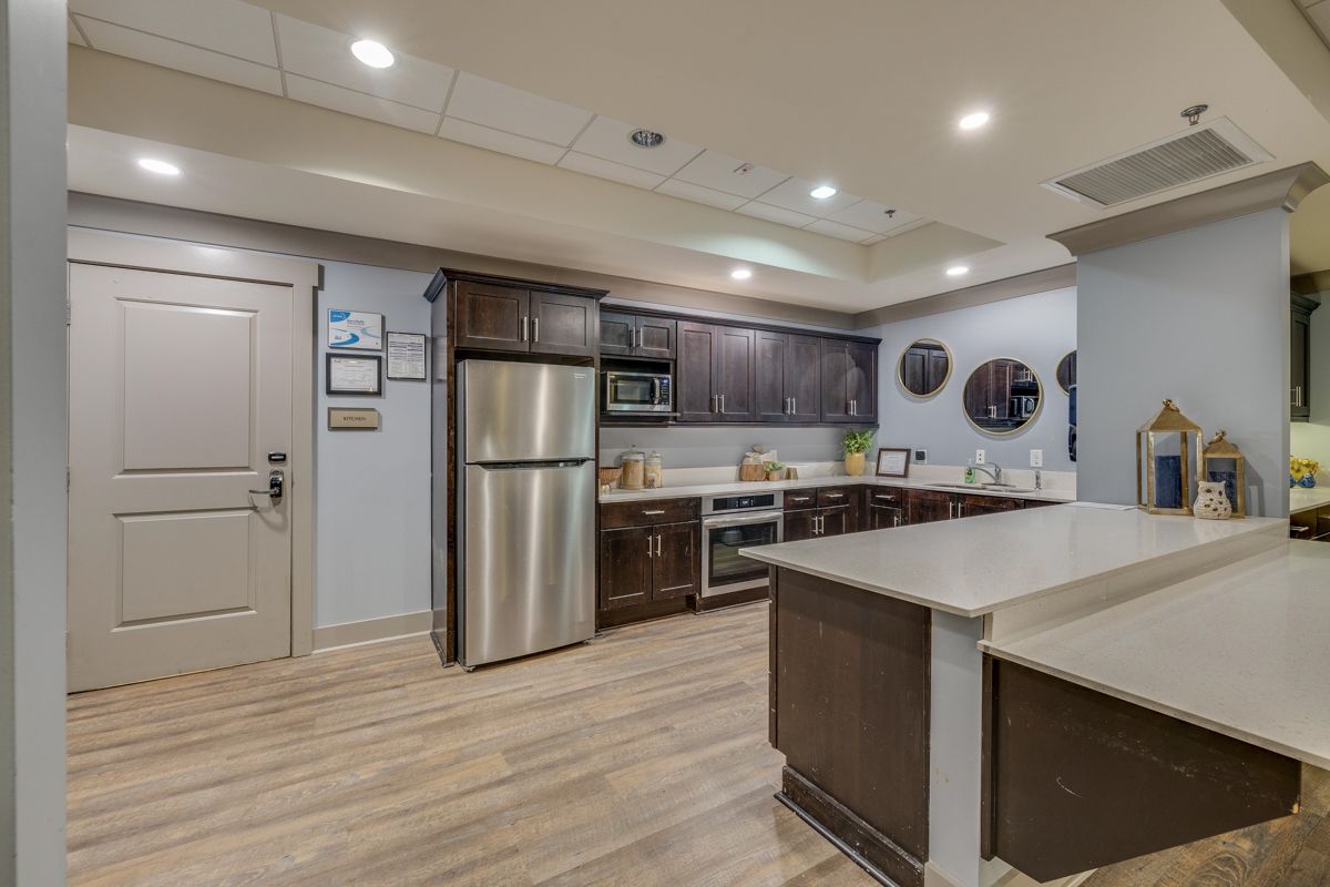 A kitchen with stainless steel appliances and wooden cabinets.