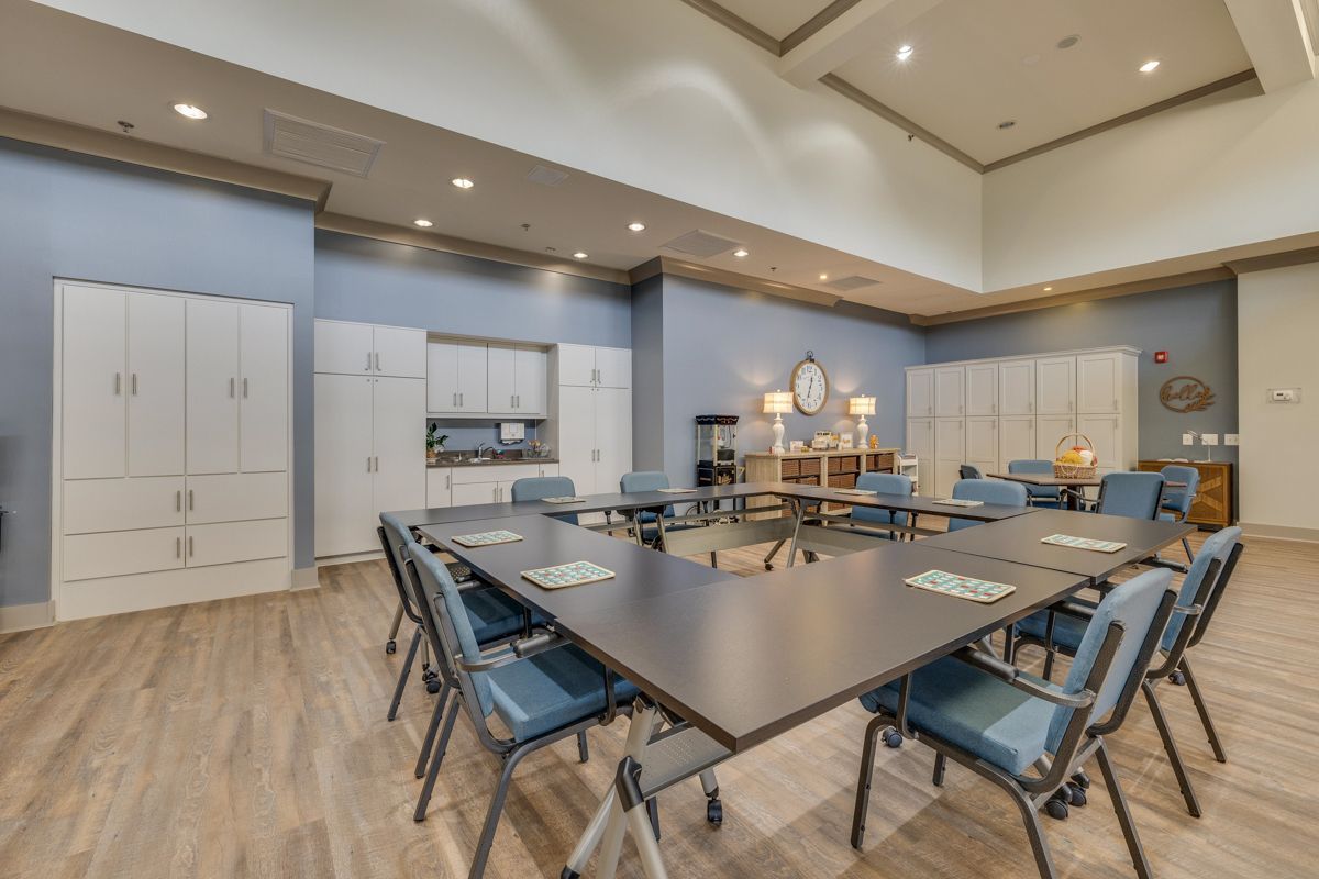 A large room with tables and chairs in it.