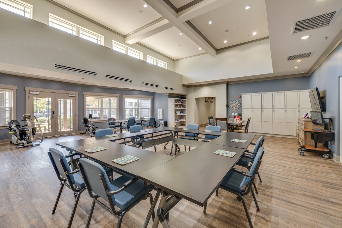 A large room with tables and chairs in it.