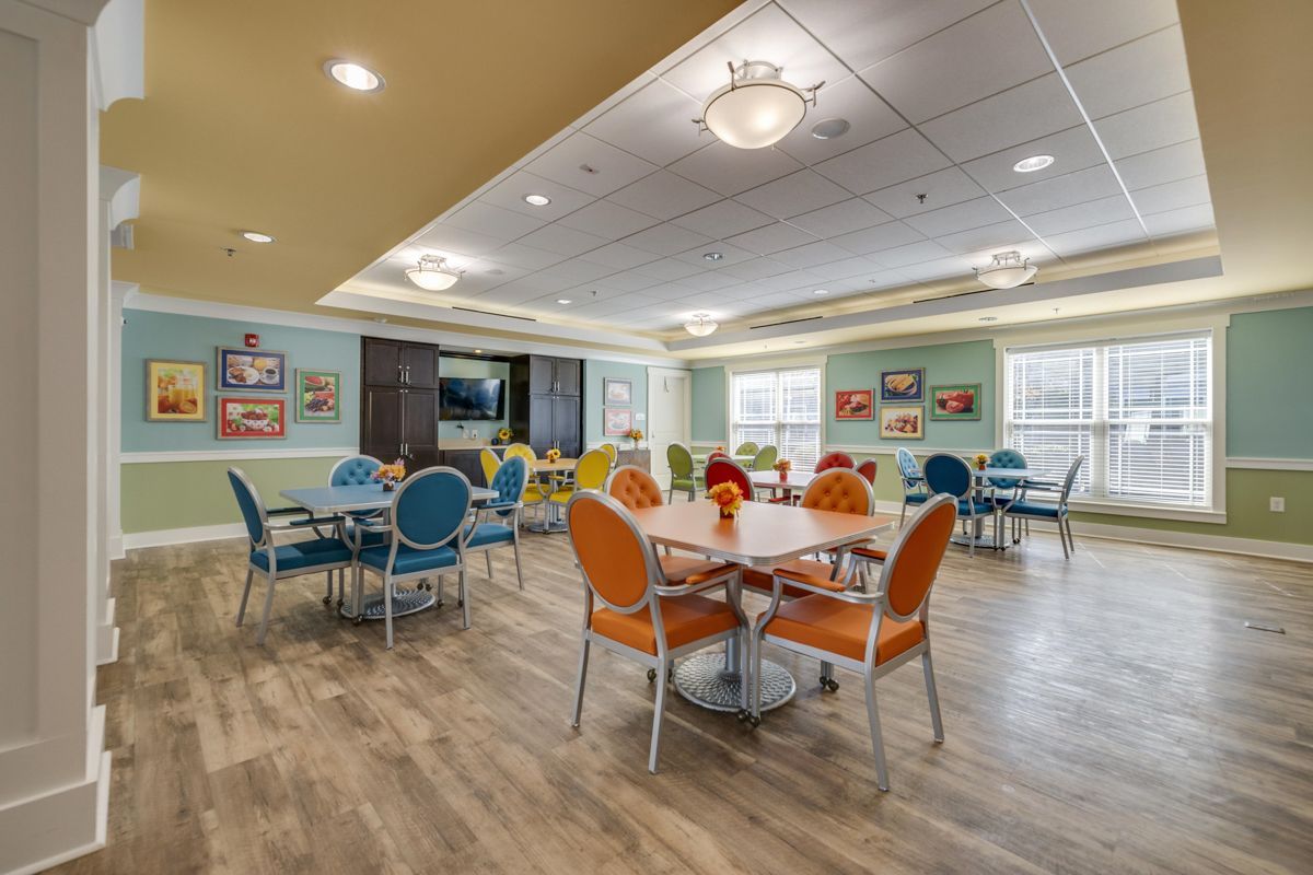A large room with tables and chairs in it.