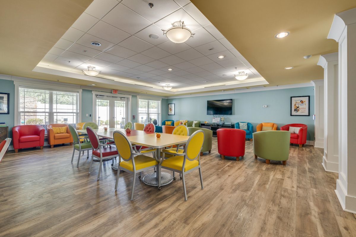A large room with tables and chairs in it.
