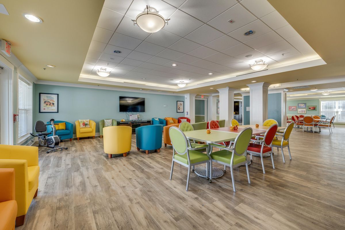 A large room with tables and chairs in it.