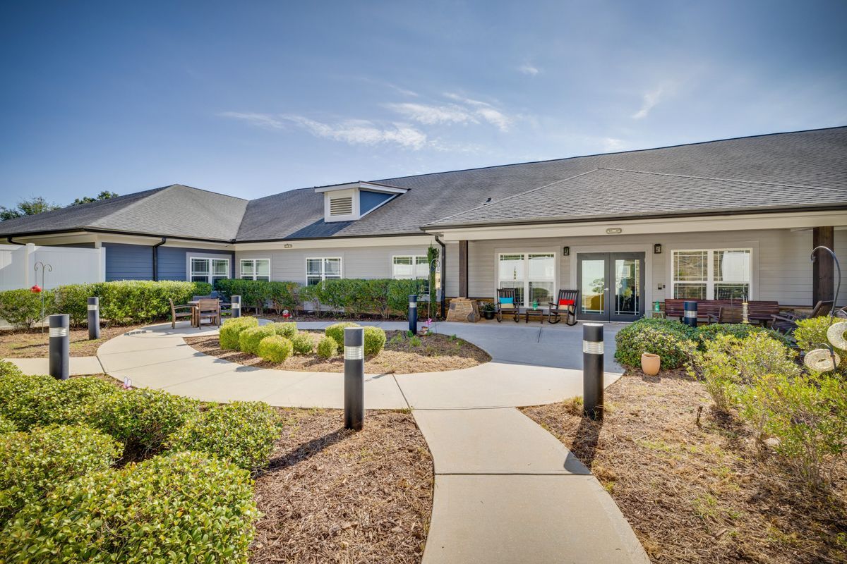 A large house with a walkway leading to it.