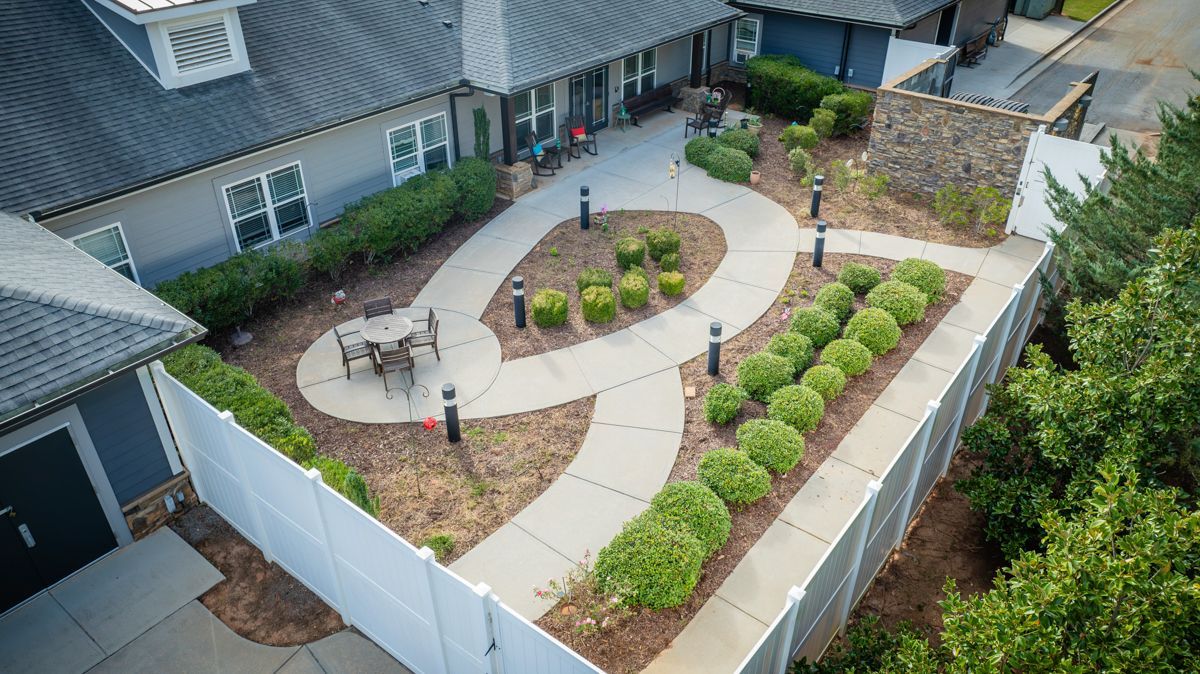 An aerial view of a patio area with a table and chairs in front of a house.