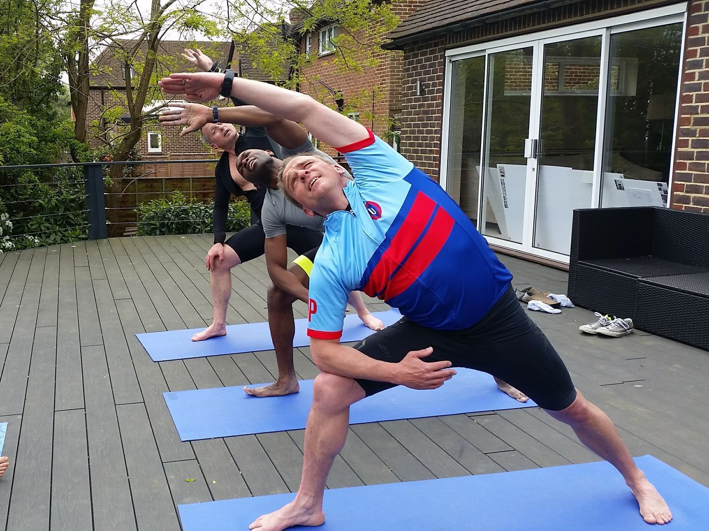 Men doing yoga outside