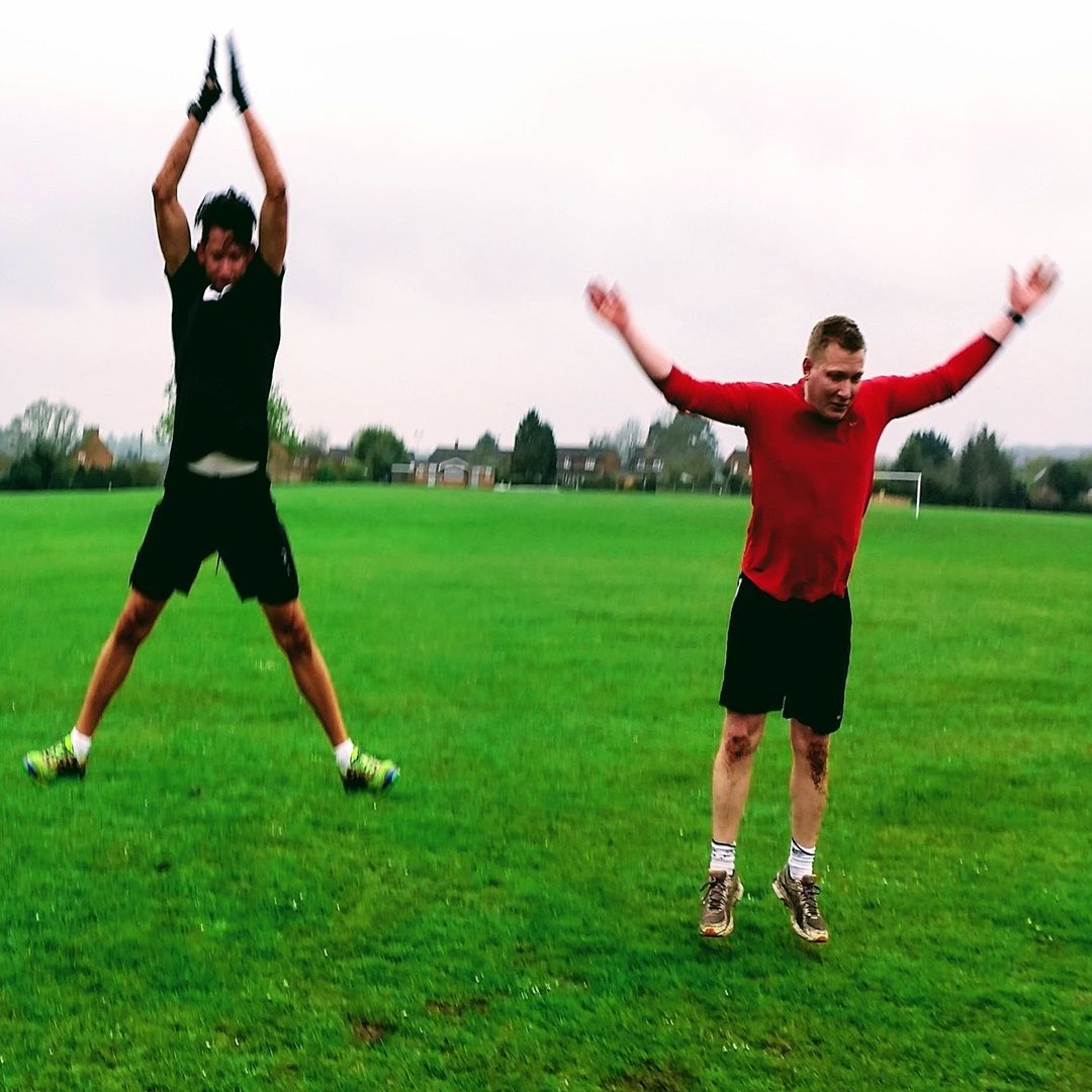 Two men jumping whilst doing exercise