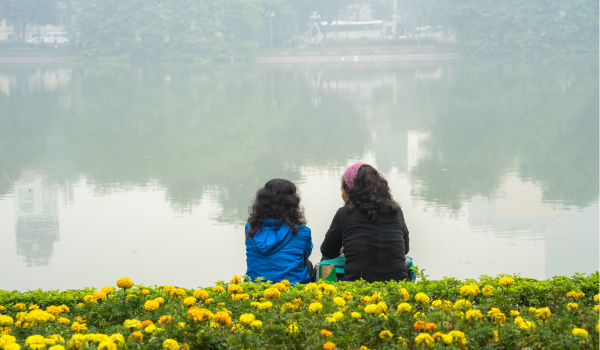 Two people sitting down talking with eachother