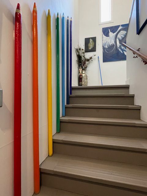 Entry way with ROYGBIV posts going into Silver Bowerbird Gallery