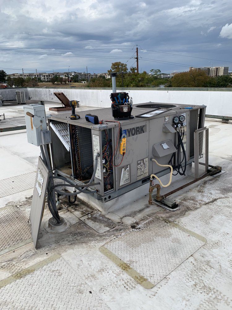 A york air conditioner is sitting on top of a roof.