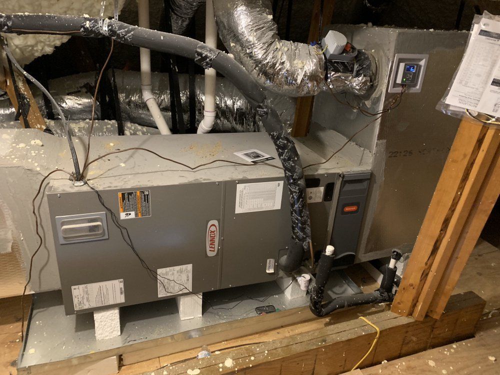 A lennox air conditioner is sitting in the attic of a house.