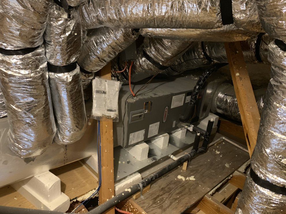 A room with a lot of ducts and pipes in it.