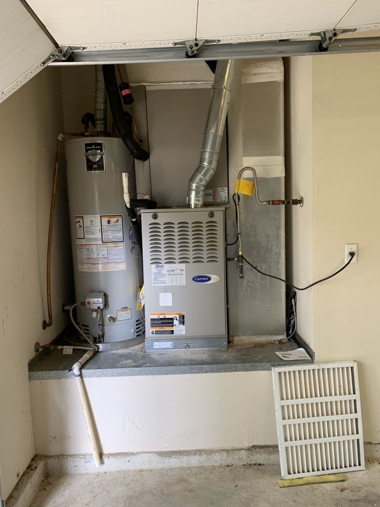 There is a water heater and an air conditioner in the garage.