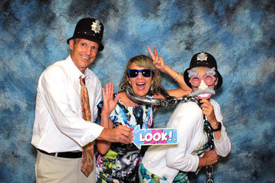 A group of people are posing for a picture in a photo booth.