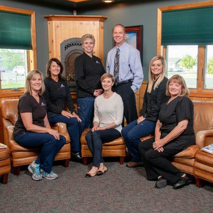 A group of people are posing for a picture in a living room.